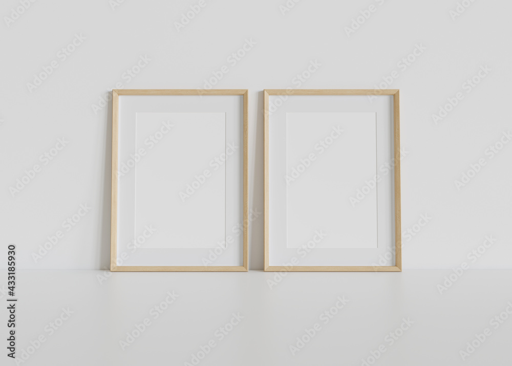 Two wooden frames leaning on white floor in interior mockup. Template of pictures framed on a wall 3D rendering Two wooden frames leaning on white floor in interior mockup. Template of pictures framed on a wall 3D rendering