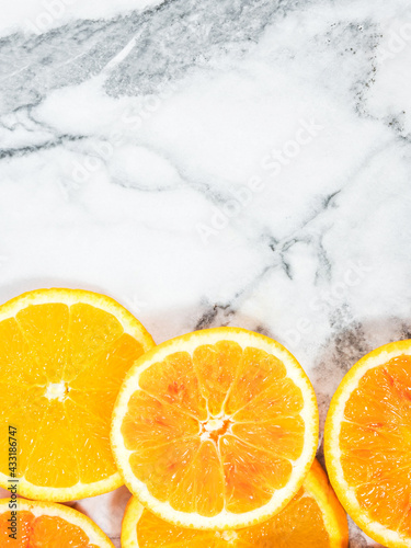 Colorful orange citrus slice fruit texture background on white marble table
