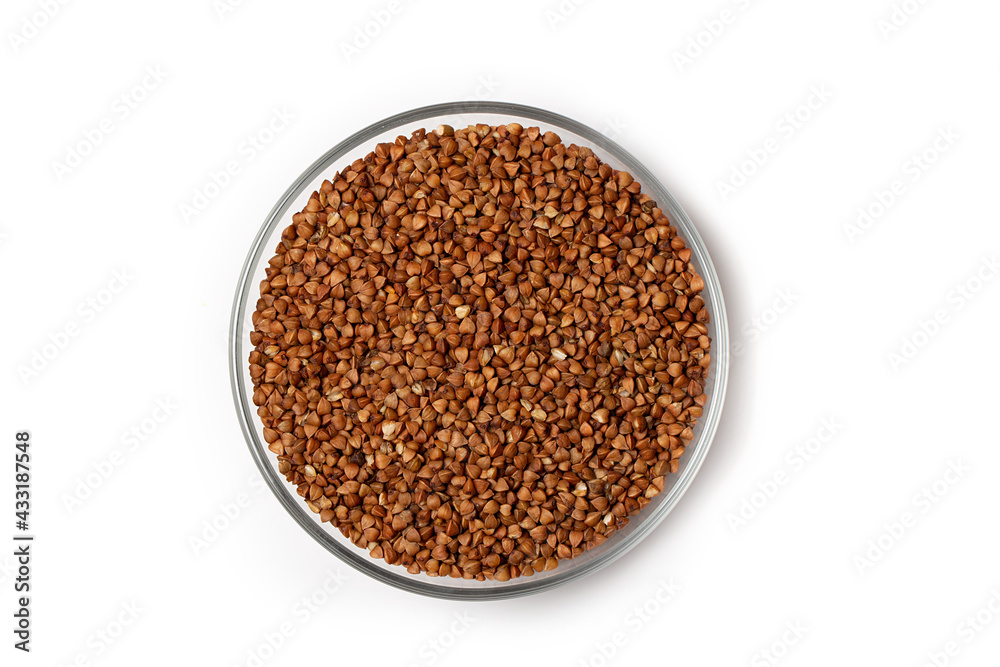 Buckwheat grains in a bowl, top view, isolated on white background. Buckwheat grains in a bowl, top view, isolated on white background.