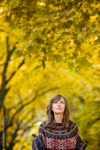 Autumn sadness concept. Woman walking in autumn park 