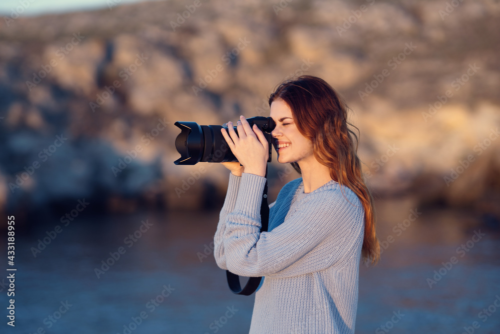 woman tourist with camera on nature rocky mountains travel professionals