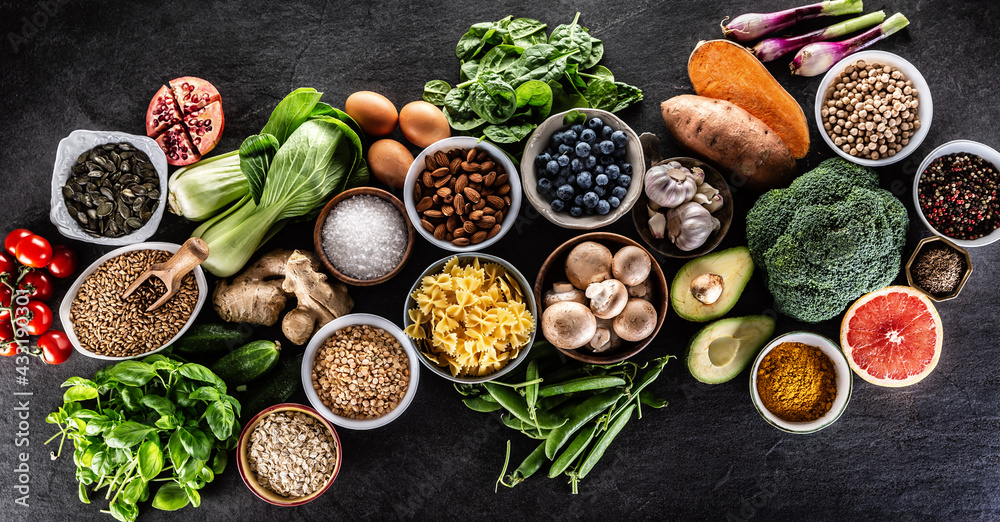 Choice of fresh food and healthy eating:.vegetables, fruits, legumes and cereals on a concrete table.