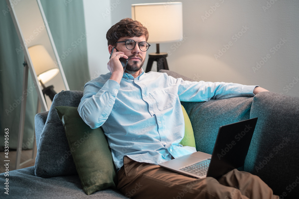 A cute manager works remotely, he puts the laptop on himself and calls his client