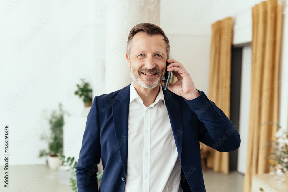 Smart middle-aged businessman chatting on his mobile phone Smart middle-aged businessman chatting on his mobile phone