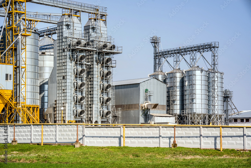 Modern Granary elevator. Silver silos on agro-processing and manufacturing plant for processing drying cleaning and storage of agricultural products, flour, cereals and grain. seed cleaning line Modern Granary elevator. Silver silos on agro-processing and manufacturing plant for processing drying cleaning and storage of agricultural products, flour, cereals and grain. seed cleaning line