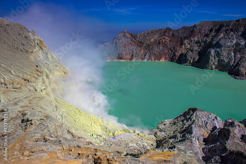 Aerial view of Kawah Ijen acid lake and sulfur mines from the top of volcano. The Ijen volcano complex is a group of composite volcanoes in the Banyuwangi Regency of East Java island, Indonesia. photo