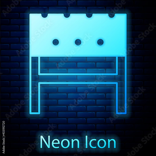 Glowing neon BBQ brazier icon isolated on brick wall background. Vector