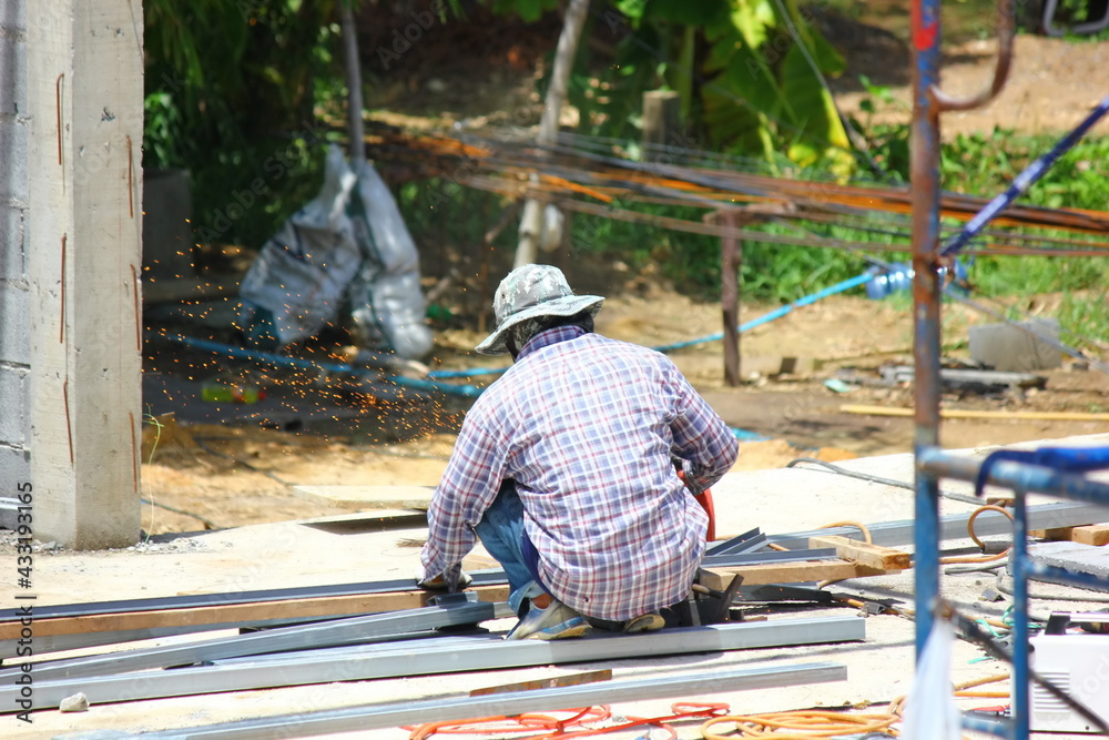 construction worker using cutting machine prepare steel stucture in ...