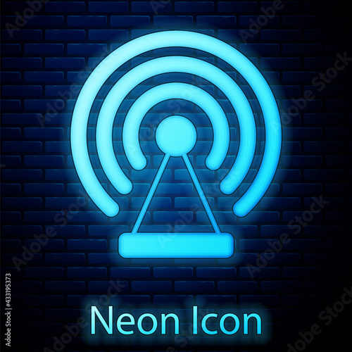 Glowing neon Radar icon isolated on brick wall background. Search system. Satellite sign. Vector