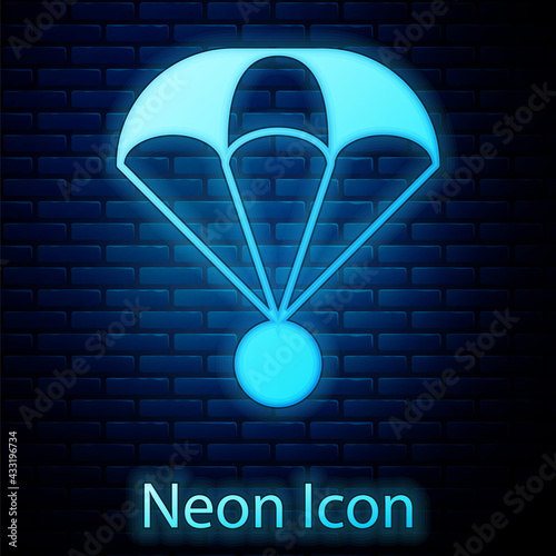 Glowing neon Parachute icon isolated on brick wall background. Extreme sport. Sport equipment. Vector