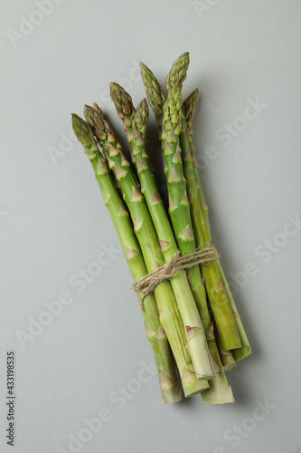 Bunch of fresh asparagus on light gray background