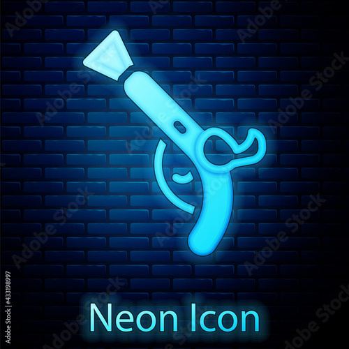 Glowing neon Vintage pistols icon isolated on brick wall background. Ancient weapon. Vector
