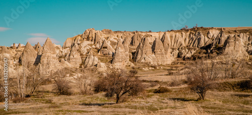 Amazing landscapes with fairy chimneys, unique rock formations and fields near Göreme, Cappadocia, Turkey