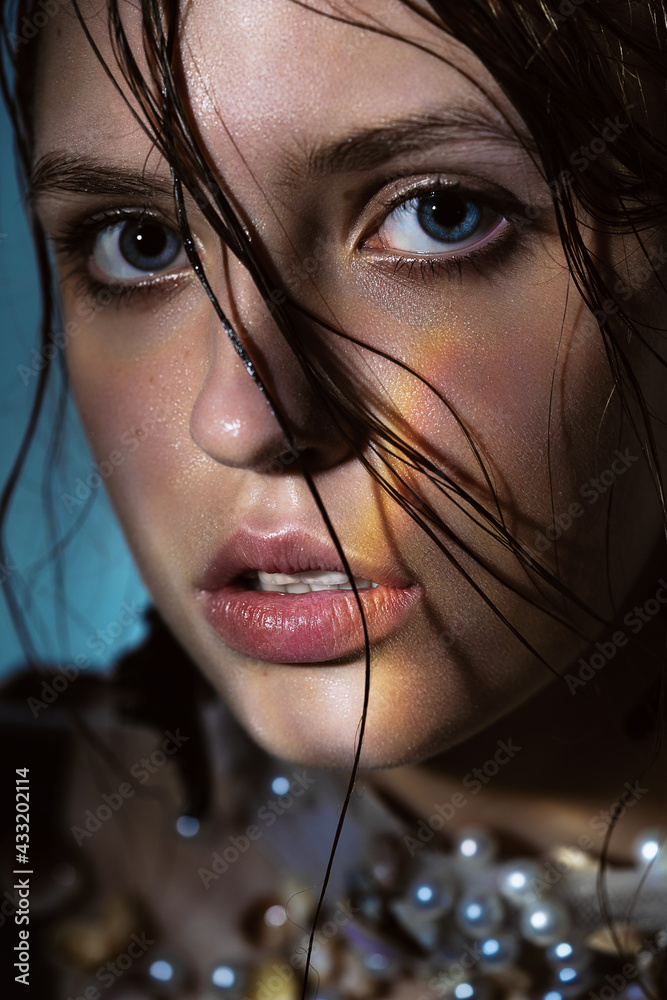 Fototapeta premium Portrait of woman with wet hair and rainbow