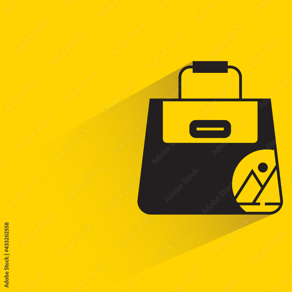 fashion bag with branding label shadow on yellow background fashion bag with branding label shadow on yellow background