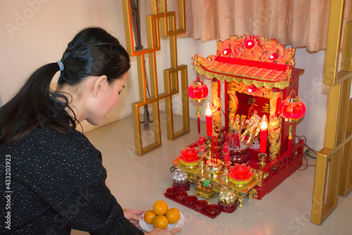 Canvas Print Asia woman worship spirit house.