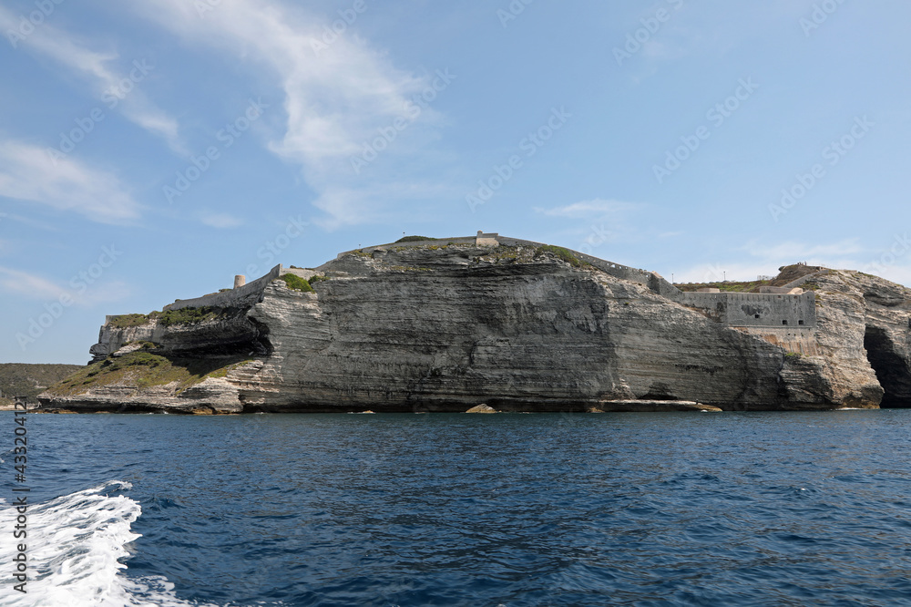 Overhanging cliff near the town of Bonifacio on the island called Corsica in the Mediterranean Sea Overhanging cliff near the town of Bonifacio on the island called Corsica in the Mediterranean Sea