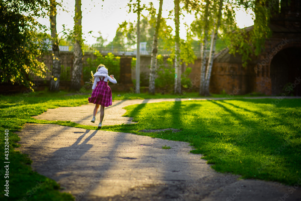 Fototapeta premium happy girl in purple dress, outdoor walks happy childhood selective focus