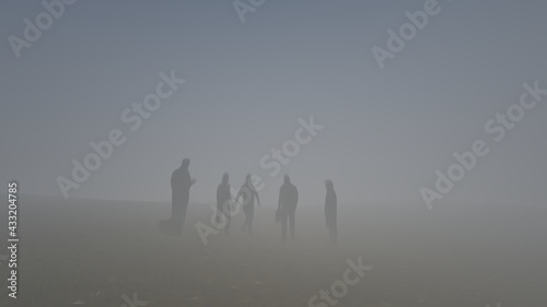 group of people walking in the fog