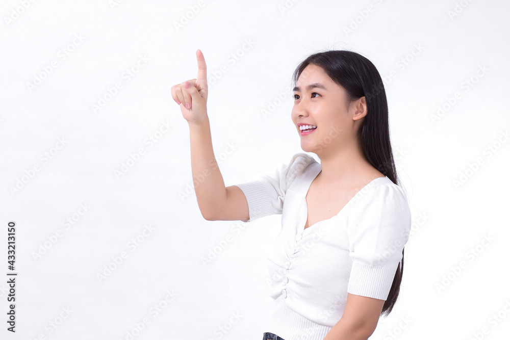 Asian girl with black long hair wears white shirt and point her hand to present something on the white background. Asian girl with black long hair wears white shirt and point her hand to present something on the white background.