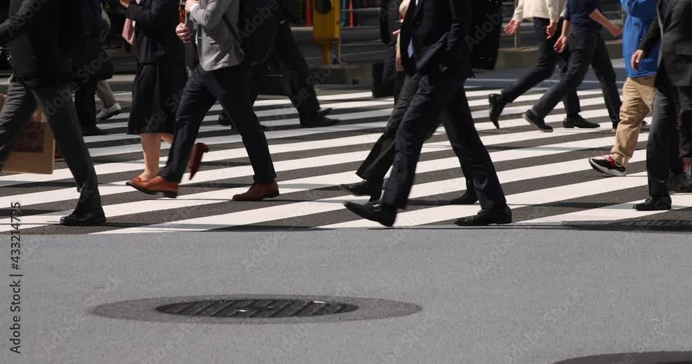 A slow motion of body parts of walking people at urban city in Tokyo