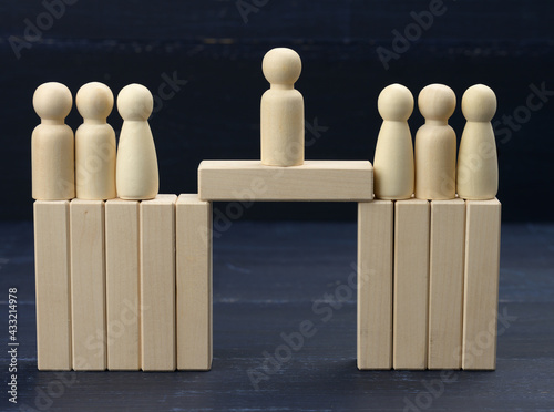 Φωτογραφία wooden men stand on the destroyed bridge on different sides on a blue background