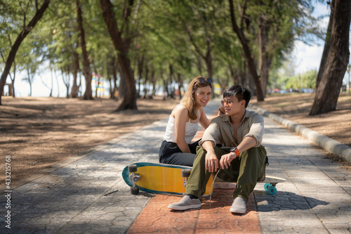 Portrait of Asian Lover Couple, With trendy Sport Equipment Surfskate © Songkhla Studio