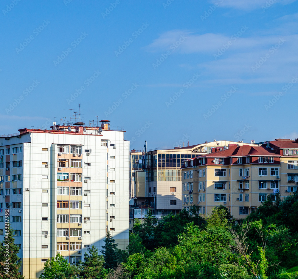 Apartment buildings with balconies and blue sky