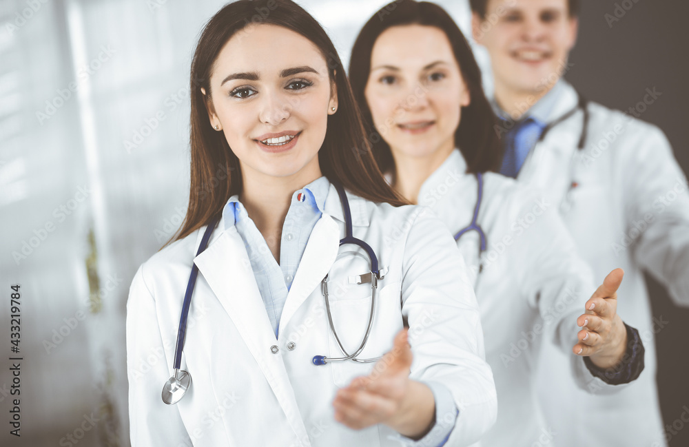 Doctors are standing as a team while offering their helping hands for shaking hand or saving people's life. Physicians are ready to help their patients. Medical help, insurance in health care, best Doctors are standing as a team while offering their helping hands for shaking hand or saving people's life. Physicians are ready to help their patients. Medical help, insurance in health care, best