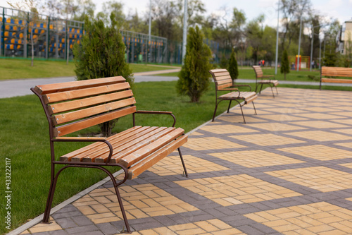 Wooden benches in the schoolyard © Larysa