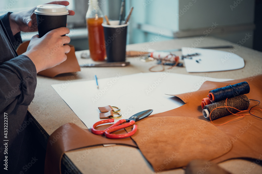 The process of creating elements of individual shoes made of genuine leather. Close-up without the shoemaker's face. Only hands The process of creating elements of individual shoes made of genuine leather. Close-up without the shoemaker's face. Only hands
