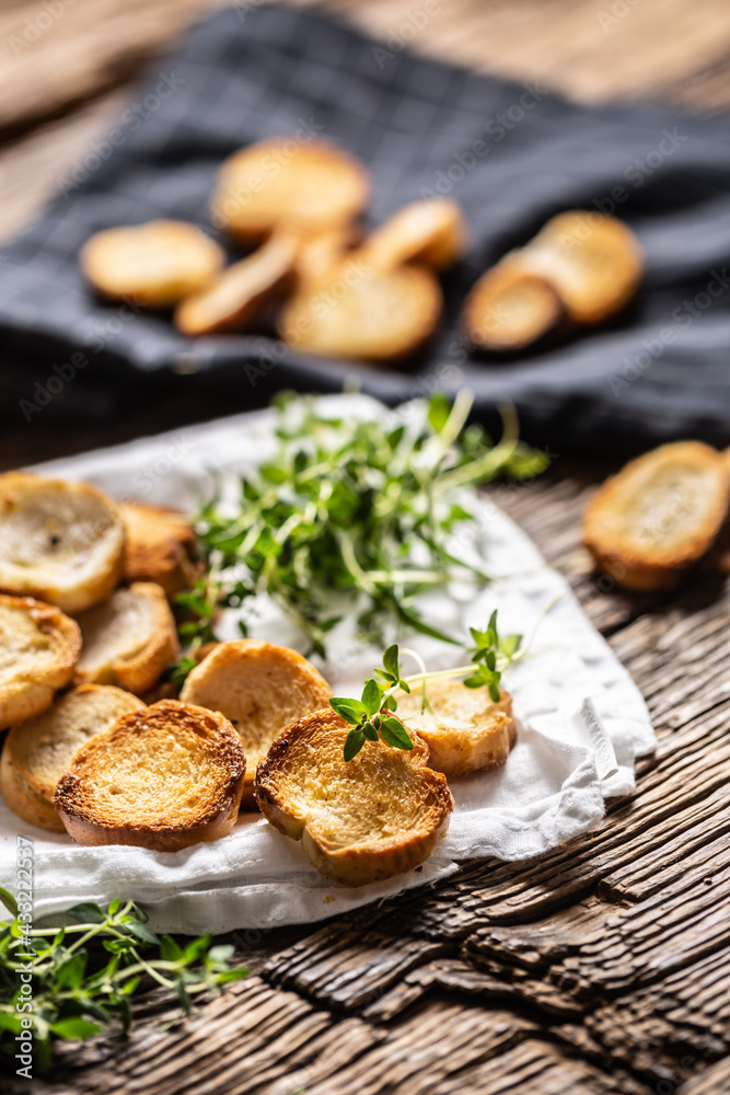 Small round mini bake rolls with lovely crunchy flavour and goldish colour made of baked bread and served in the paper or dish cloth with thyme Small round mini bake rolls with lovely crunchy flavour and goldish colour made of baked bread and served in the paper or dish cloth with thyme