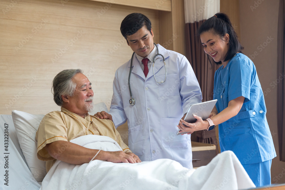 Doctor and nurse using tablet computer to share test results with patient. Doctor and nurse using tablet computer to share test results with patient.