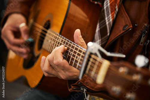 Fotografie Young hipster man plays guitar.