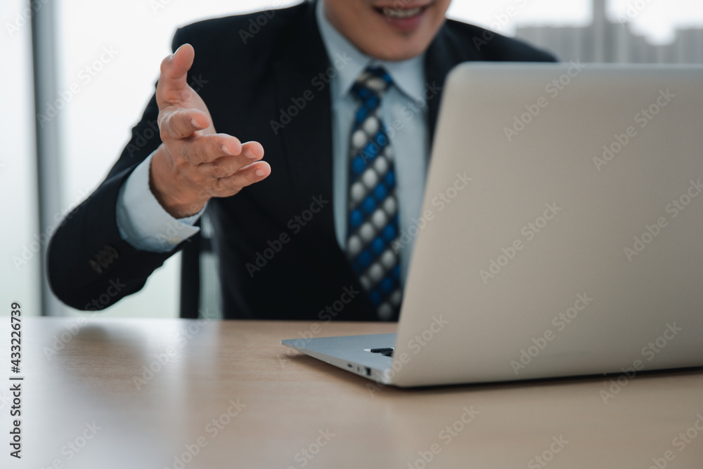 Businessman having video call via laptop in the office