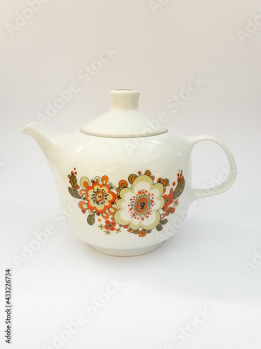 Mid-century modern porcelain teapot with flower pattern isolated