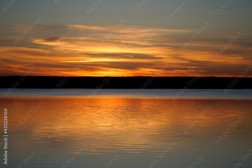 Sunset on the Plavno lake in the Berezinsky nature reserve. Horizon and reflection. Red paints a bright sky. Belarusian landscape.	