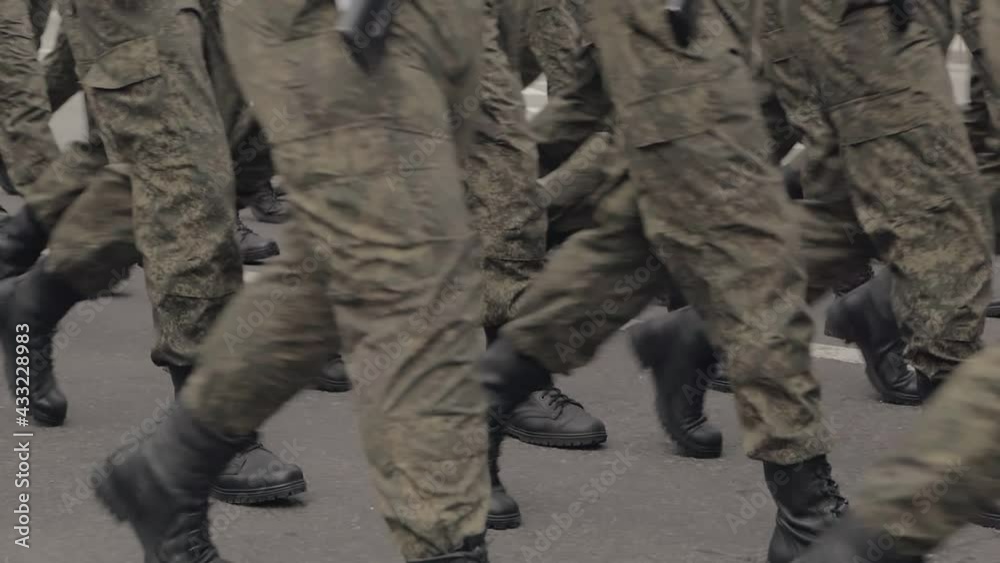 A special forces unit marching through the square. Only the legs are visible in the frame.