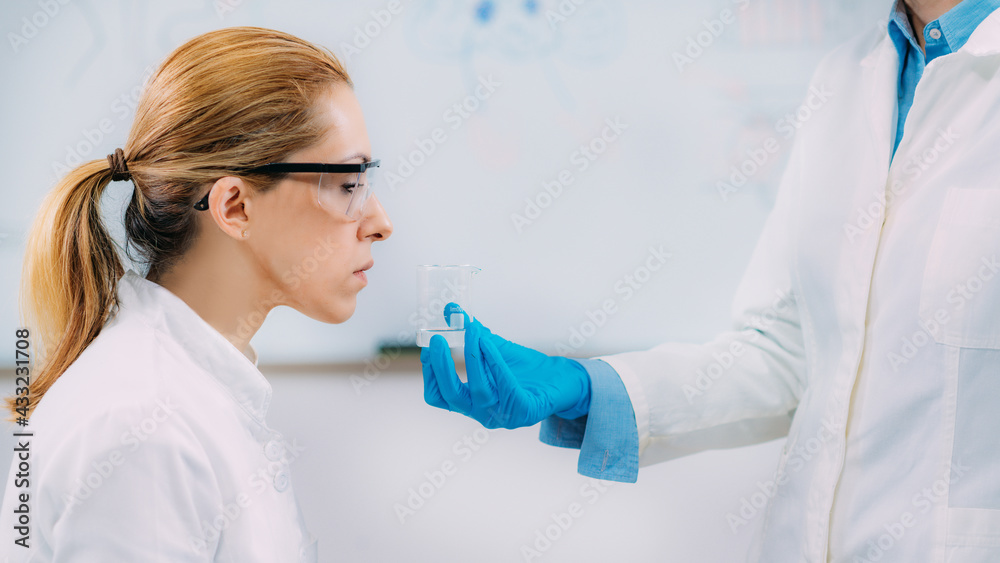 Scientists Examining The Smell Of A Substance. Olfaction Laboratory Test. Scientists Examining The Smell Of A Substance. Olfaction Laboratory Test.