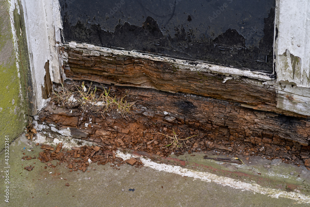 Wooden frame of an old window with peeling paint and rotten wood Wooden frame of an old window with peeling paint and rotten wood