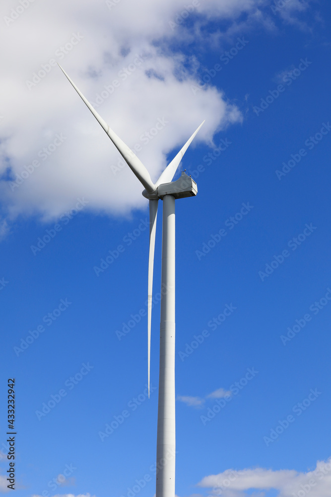 Wind Turbine against Blue Sky and White Clouds Wind Turbine against Blue Sky and White Clouds