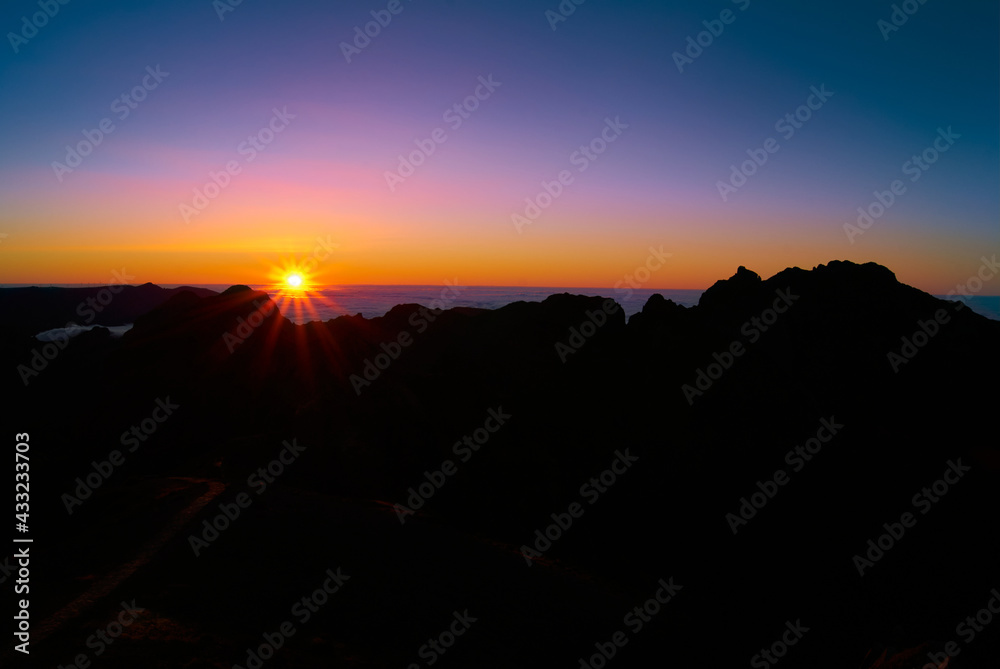 sunset above clouds on mountain highland peaks, Madeira Island, Pico do Areeiro, 1818 meters altitude