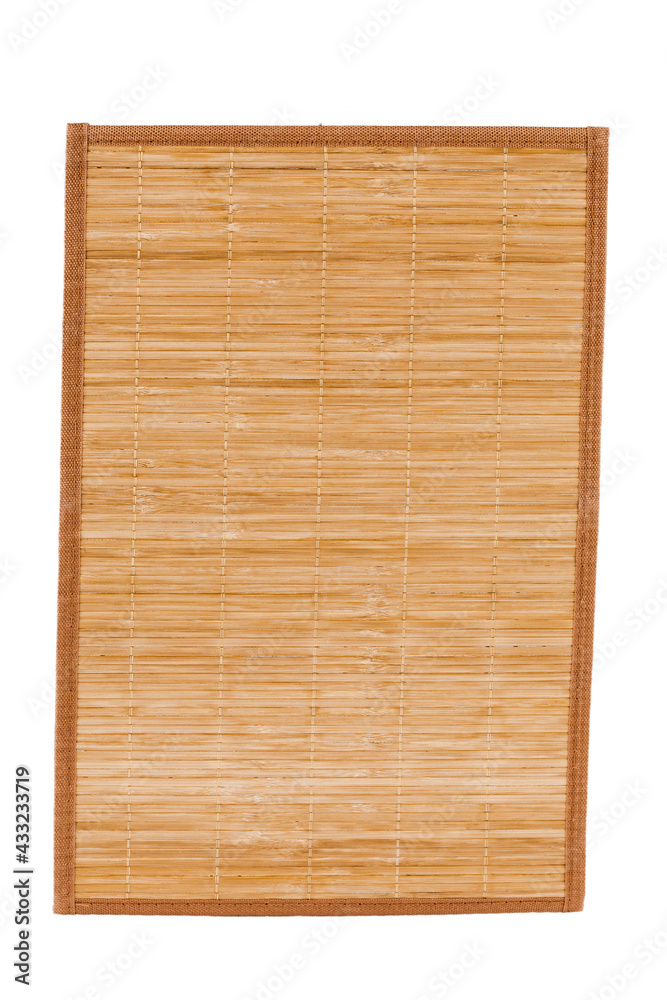 Naklejka premium Bamboo straw serving mat isolated over white background.