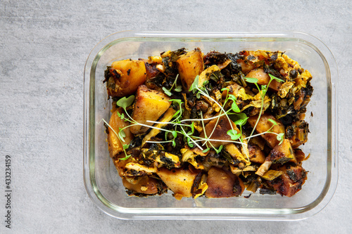 Meal with potatoes, cabbage and kale leaves in glassware. Indian vegetarian cuisine Subji meal.