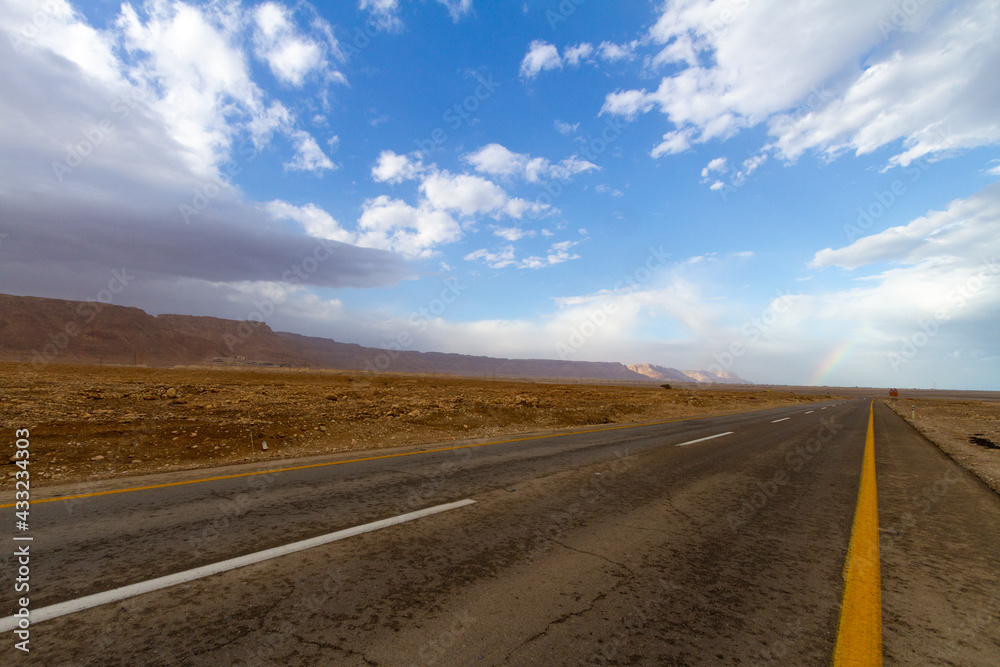 Dead sea asphalt road with white clouds and blue sky. Dead sea asphalt road with white clouds and blue sky.