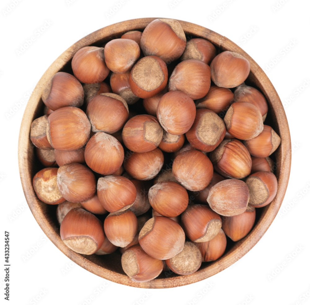 Unpeeled hazelnuts in a cup isolated on white background. hazelnuts in shell Unpeeled hazelnuts in a cup isolated on white background. hazelnuts in shell