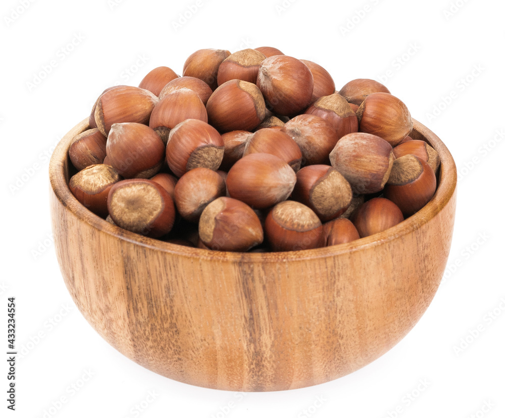 Unpeeled hazelnuts in a cup isolated on white background. hazelnuts in shell Unpeeled hazelnuts in a cup isolated on white background. hazelnuts in shell