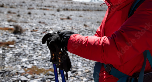 Woman hiker checking the altitude on sportswatch in winter tibet