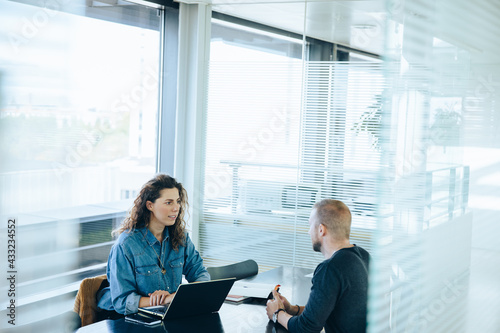 Businesswoman interviewing male job candidate photo