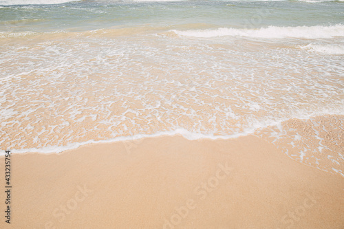 Soft wave on the sandy beach, summer background.